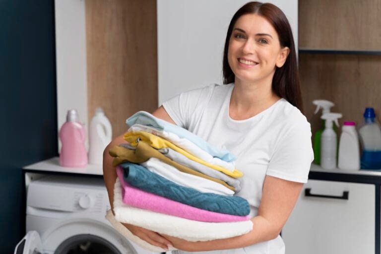 woman-holding-pile-clean-clothes